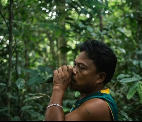 Filipino man drinking potion in forest